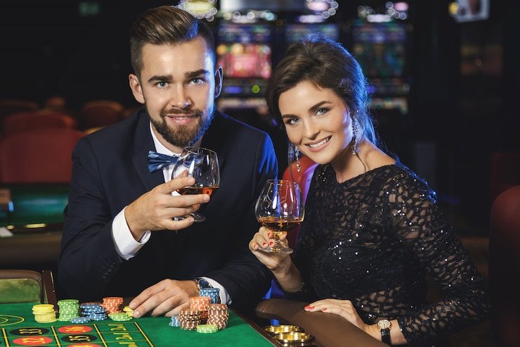 Live roulette wheel with professional dealer spinning and players placing bets